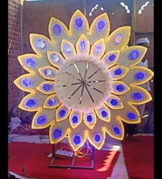 Beautiful Indian handicraft decoration with traditional accessories and cream artificial flowers in a golden vase.