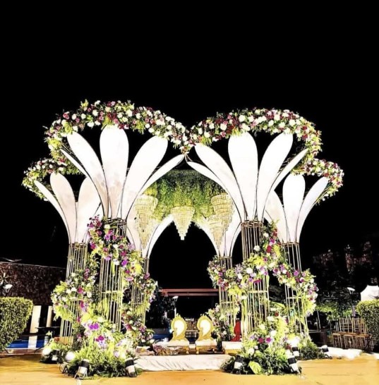 Elegant wedding tent light decoration with warm fairy lights, hanging fixtures, and cream fabric draping.