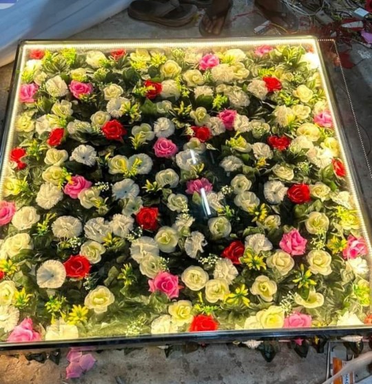 Gujarat-inspired handicrafts featuring colourful embroidered textiles, traditional decorative objects, terracotta accents, and artificial flowers.