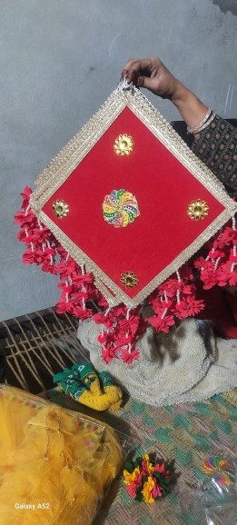 Colorful Gujarat-inspired handicrafts featuring embroidered textiles, Bandhani patterns, and traditional decorative objects.