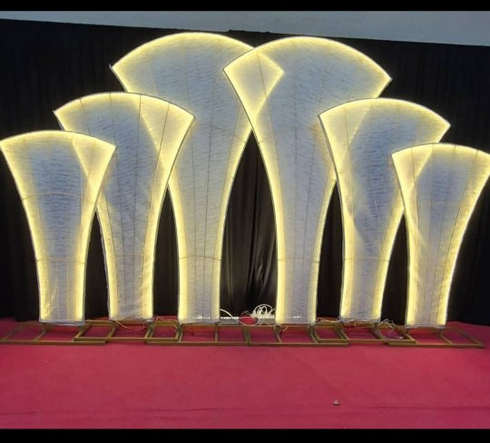 Artificial flowers and handcrafted decoration crafts arranged for an elegant party or event backdrop.